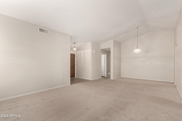 empty room with light colored carpet and lofted ceiling