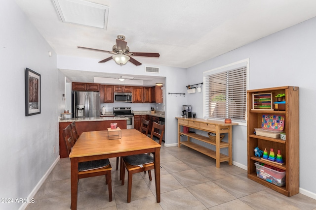 tiled dining space with ceiling fan