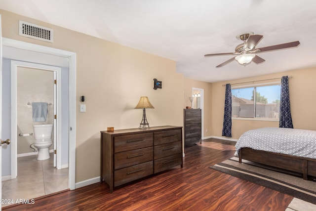 bedroom with dark wood-type flooring, ensuite bath, and ceiling fan