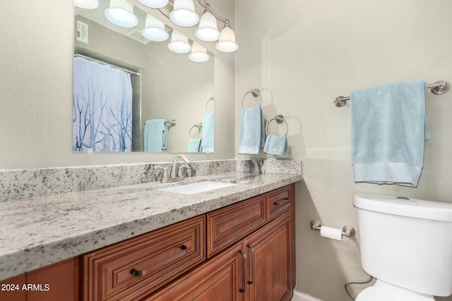 bathroom with toilet and vanity