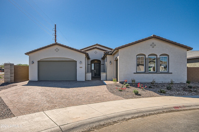 mediterranean / spanish house with a garage