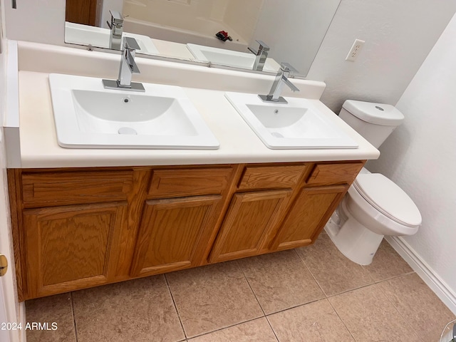 bathroom featuring vanity, tile patterned floors, and toilet