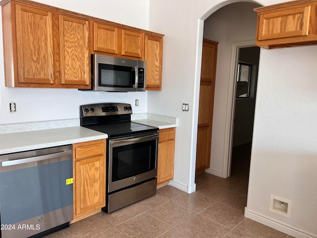 kitchen with appliances with stainless steel finishes and tile patterned floors