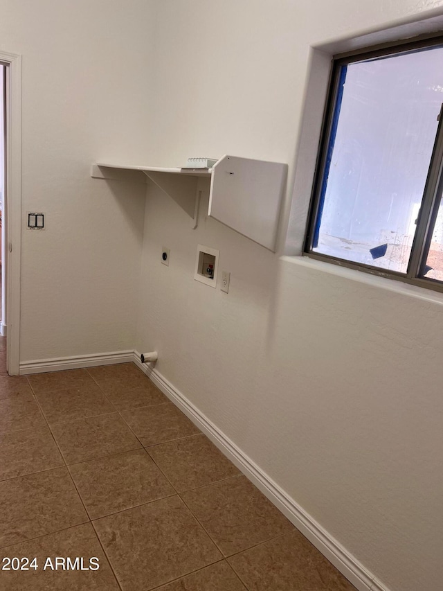 clothes washing area with dark tile patterned floors, washer hookup, and electric dryer hookup