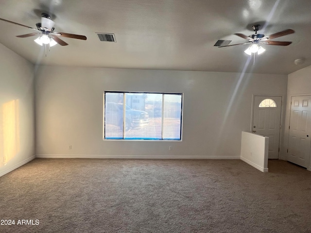 unfurnished room featuring lofted ceiling, carpet flooring, and ceiling fan