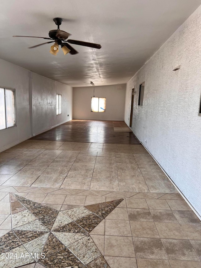 spare room with a wealth of natural light, ceiling fan, and vaulted ceiling