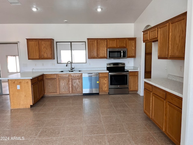 kitchen with tile patterned flooring, sink, and appliances with stainless steel finishes