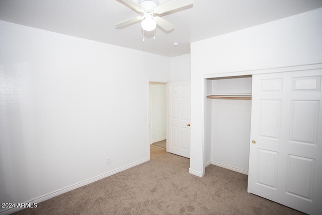 unfurnished bedroom featuring a closet, light carpet, and ceiling fan