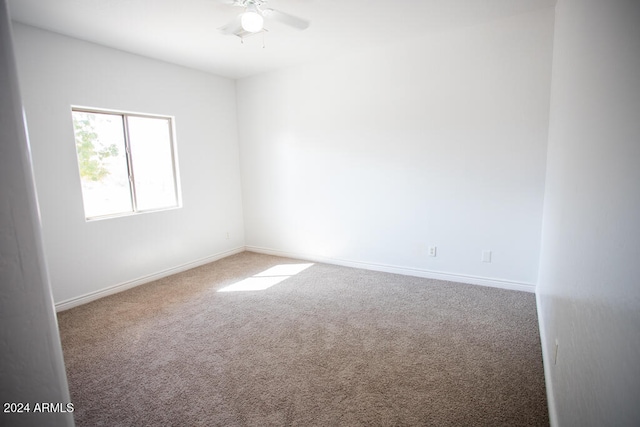 empty room featuring carpet floors and ceiling fan