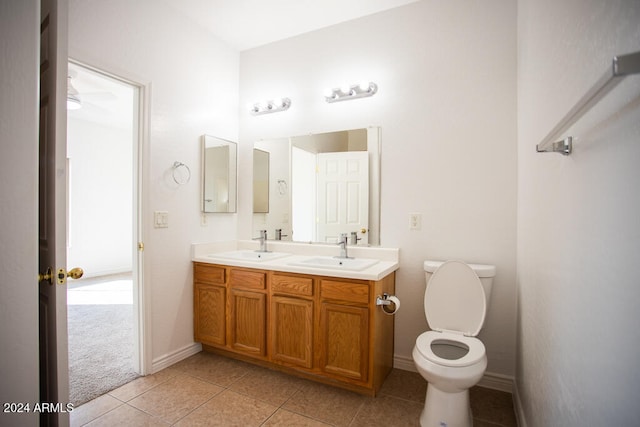 bathroom featuring toilet, vanity, and tile patterned floors