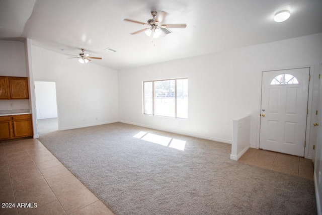 unfurnished living room featuring ceiling fan and light colored carpet