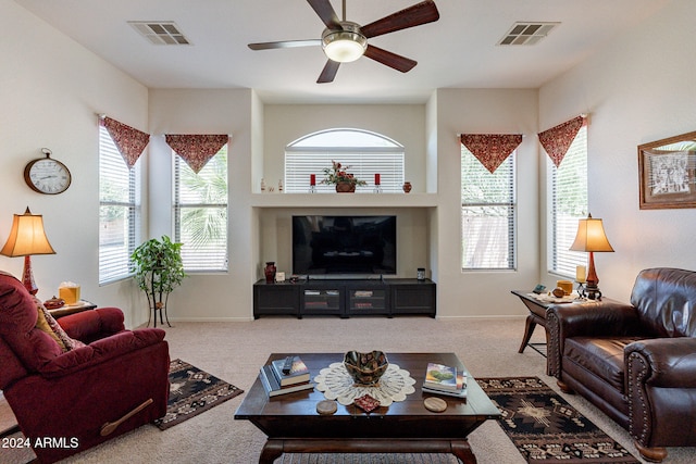 living room featuring carpet and ceiling fan