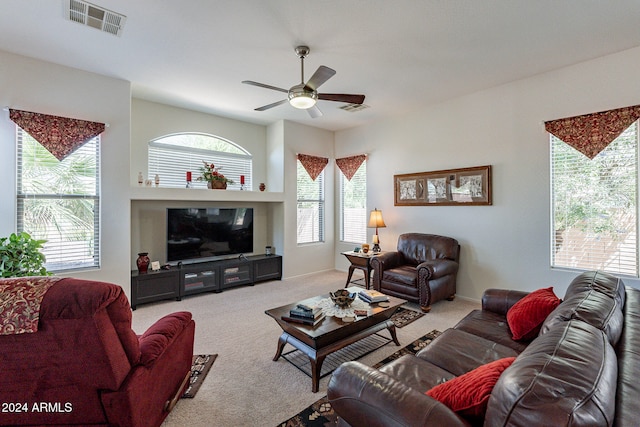 carpeted living room with ceiling fan