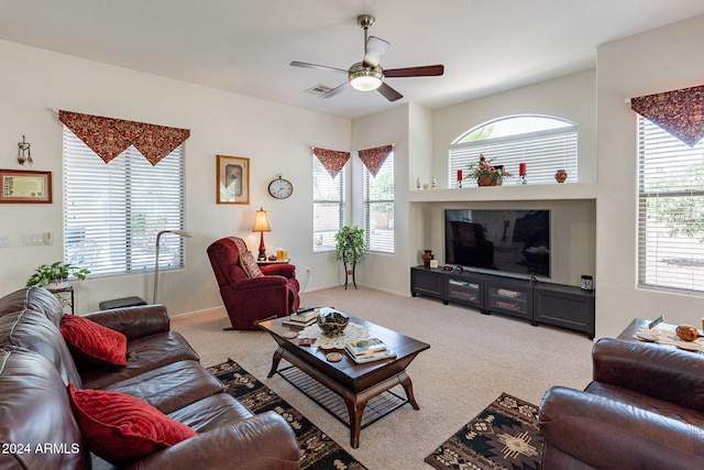 carpeted living room with ceiling fan