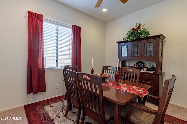 dining area with carpet and ceiling fan