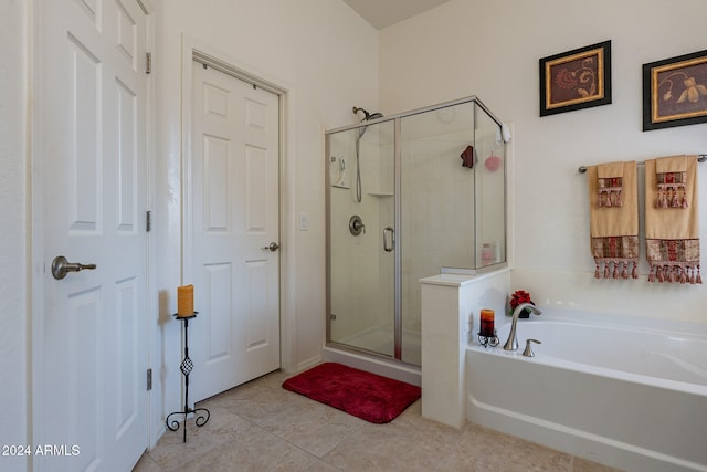 bathroom featuring tile patterned flooring and shower with separate bathtub