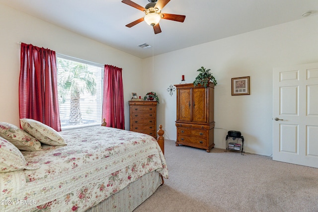 bedroom featuring light carpet and ceiling fan