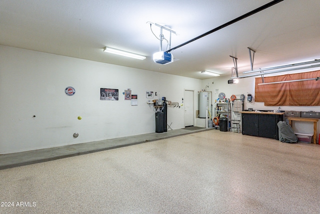 garage with electric water heater and a garage door opener