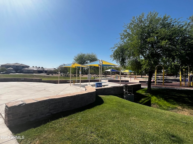 exterior space with a playground and a yard