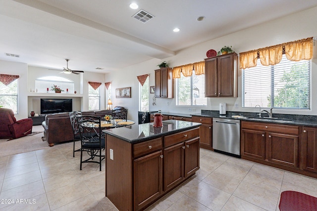 kitchen featuring light tile patterned flooring, sink, ceiling fan, a kitchen island, and dishwasher