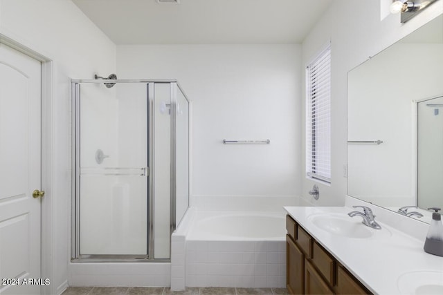 full bath with visible vents, a sink, a shower stall, double vanity, and a bath