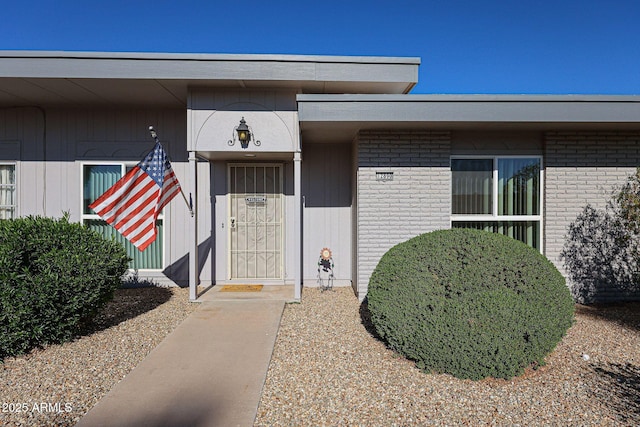 property entrance featuring brick siding