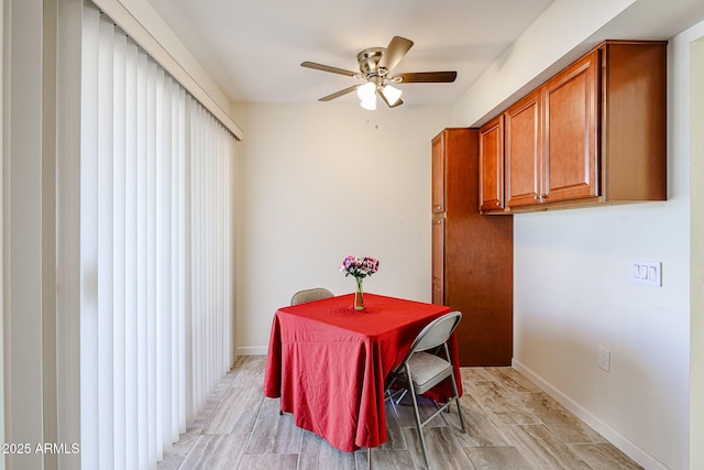 dining room featuring baseboards and ceiling fan