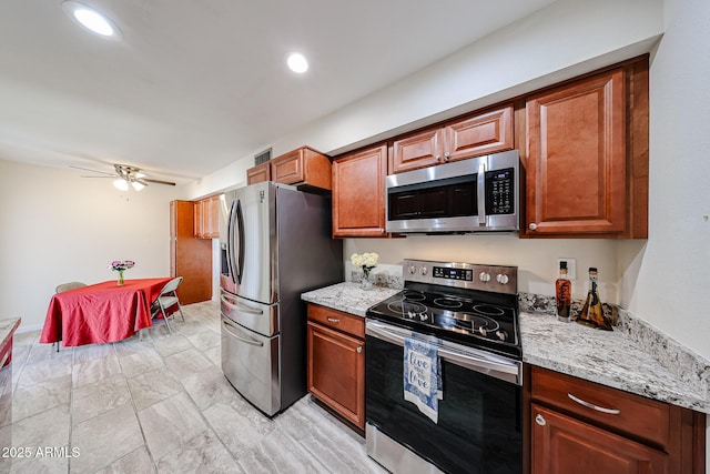 kitchen with recessed lighting, light stone counters, ceiling fan, and appliances with stainless steel finishes