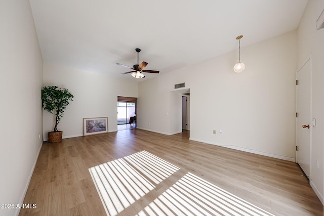 unfurnished living room with baseboards, ceiling fan, visible vents, and light wood finished floors