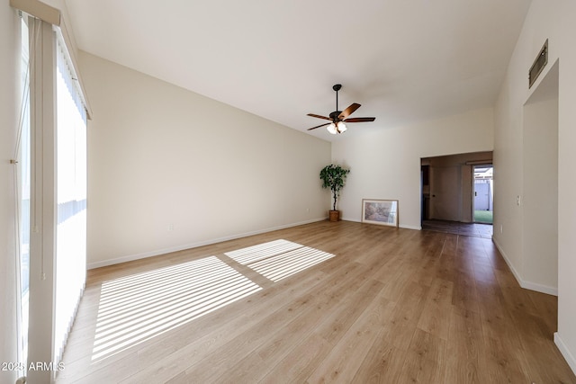 unfurnished room with a ceiling fan, baseboards, and light wood-style floors