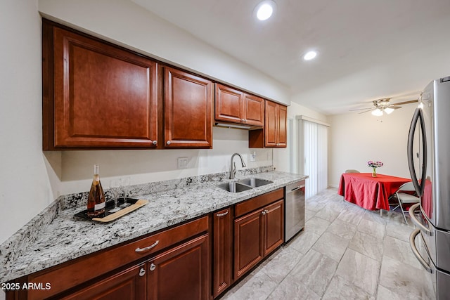 kitchen with recessed lighting, a sink, ceiling fan, light stone countertops, and appliances with stainless steel finishes