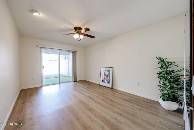 unfurnished room featuring baseboards, ceiling fan, and light wood finished floors