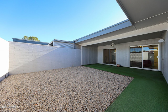 view of yard featuring a fenced backyard, a patio area, and a ceiling fan