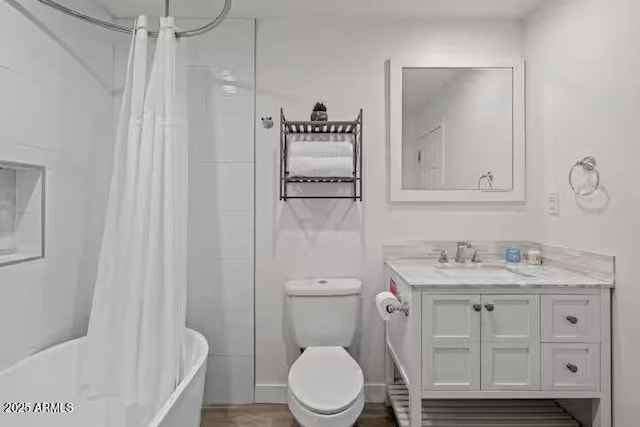 full bathroom featuring shower / bath combo with shower curtain, toilet, and vanity