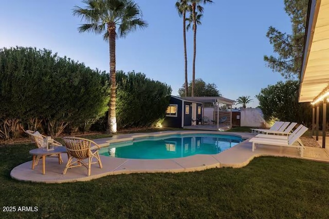 view of swimming pool featuring a yard and a patio