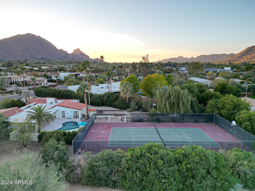 view of tennis court featuring a mountain view