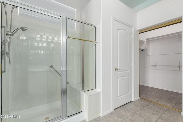 bathroom with tile patterned floors and walk in shower