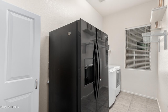 washroom featuring light tile patterned flooring and washer and dryer