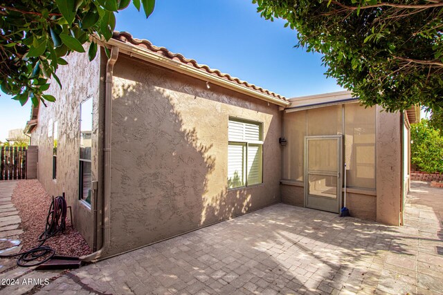 view of side of home with a patio