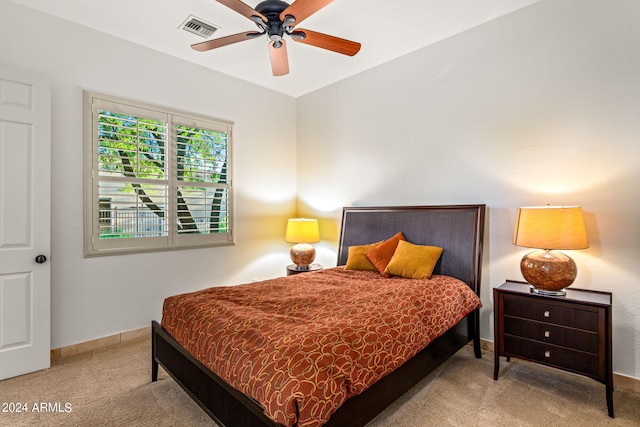 bedroom featuring ceiling fan and light carpet