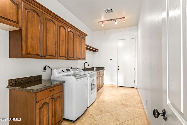 laundry room featuring cabinets, rail lighting, sink, light tile patterned floors, and washing machine and clothes dryer