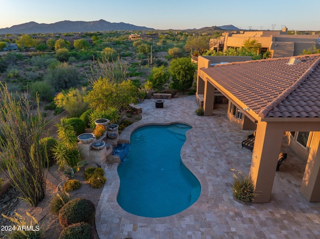 view of pool with a patio area and a mountain view