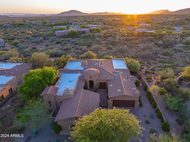 aerial view at dusk featuring a mountain view