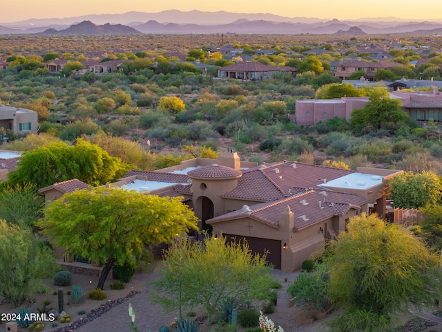 aerial view at dusk featuring a mountain view