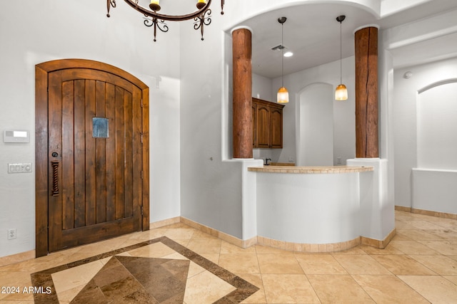 entrance foyer with an inviting chandelier and light tile patterned flooring