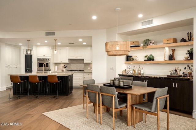 dining area with visible vents, wood finished floors, and recessed lighting