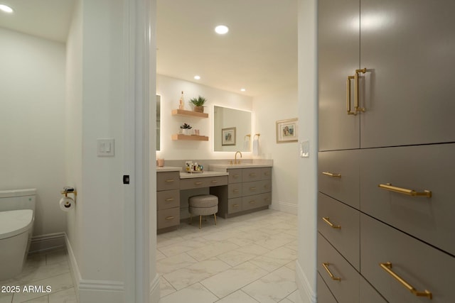 bathroom with marble finish floor, recessed lighting, toilet, vanity, and baseboards