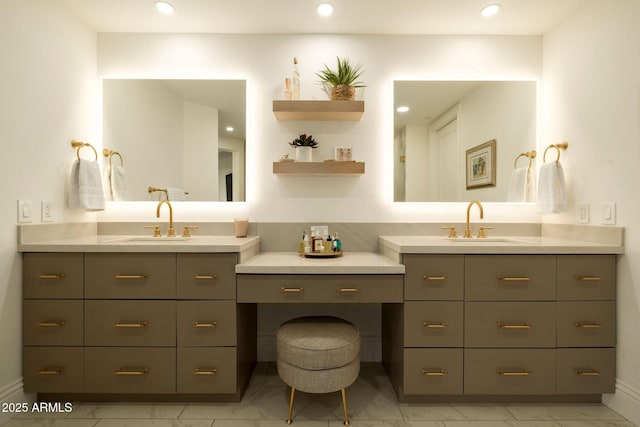 bathroom featuring marble finish floor, two vanities, and a sink