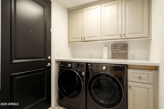 laundry room featuring washing machine and dryer and cabinet space