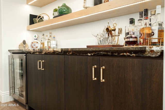 bar featuring wine cooler and a dry bar